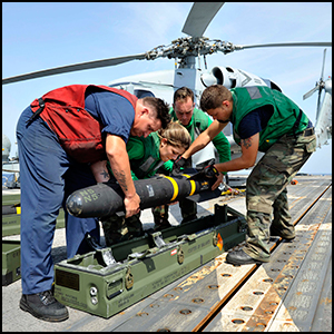 Sailor lower [sic] a Hellfire missile into it's case by Official U.S. Navy Page via Flickr https://flic.kr/p/dpaBVh [Public Domain - Work of U.S. Government]